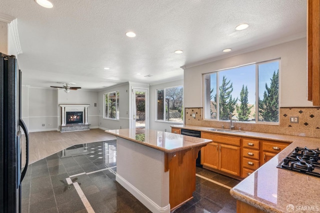 5317 Judsonville Dr, Antioch, CA 94531 - kitchen featuring black appliances, a sink, recessed lighting, crown molding, and a glass covered fireplace