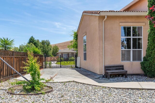 5317 Judsonville Dr, Antioch, CA 94531 - view of side of home with stucco siding, fence, and a patio area