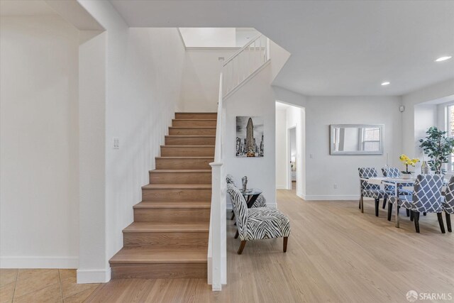 stairway with hardwood / wood-style flooring