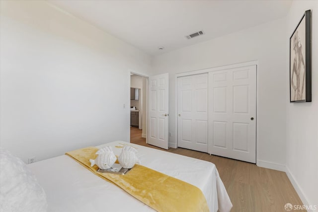 bedroom featuring a closet and wood-type flooring