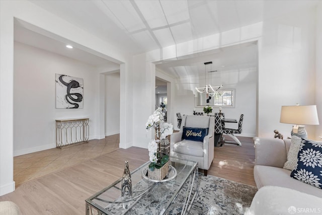 living room featuring hardwood / wood-style floors and a notable chandelier