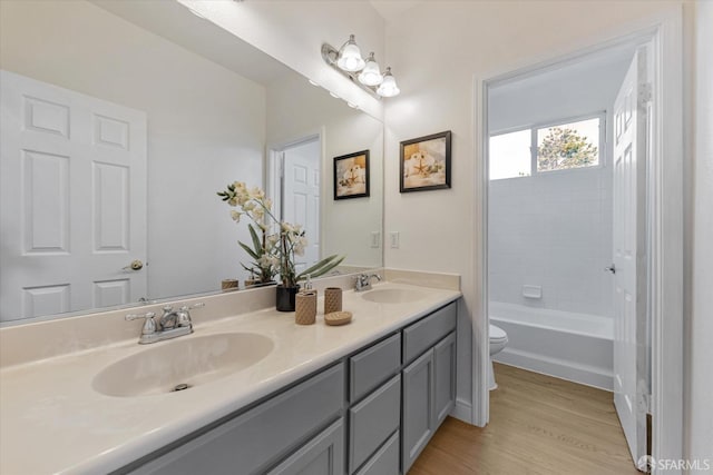 bathroom featuring toilet, vanity, and hardwood / wood-style floors