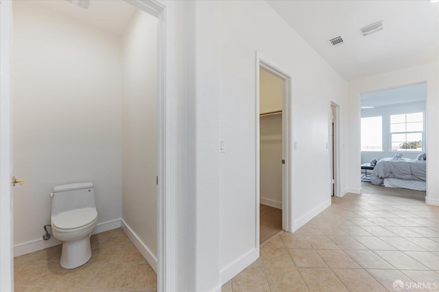 bathroom featuring tile patterned flooring and toilet