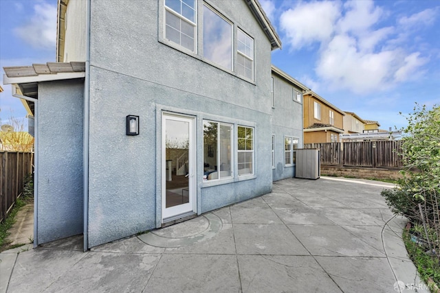 back of property featuring a patio