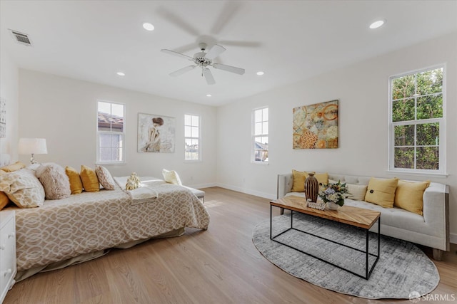 bedroom with ceiling fan and light hardwood / wood-style flooring