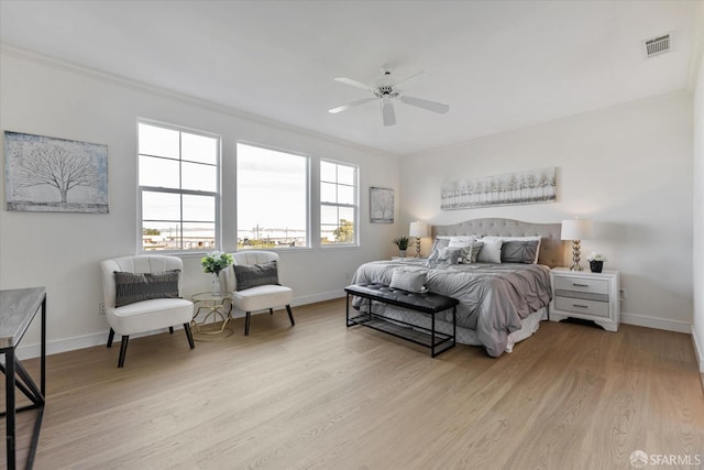 bedroom with ceiling fan, light hardwood / wood-style flooring, and crown molding