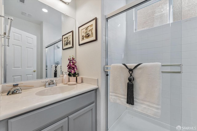 bathroom featuring an enclosed shower and vanity