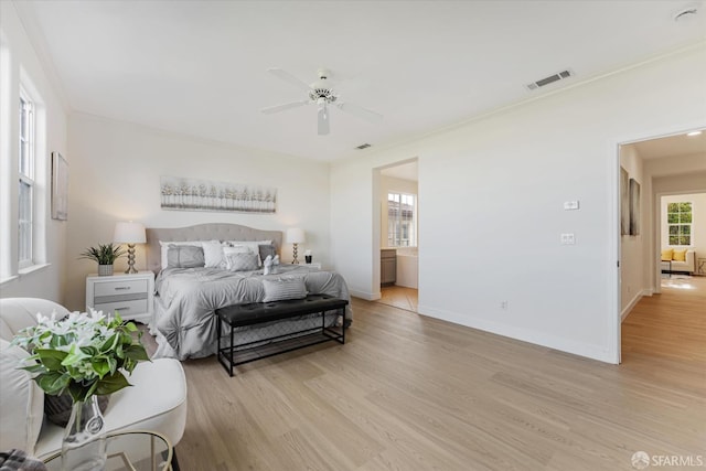 bedroom featuring crown molding, ceiling fan, and light hardwood / wood-style flooring