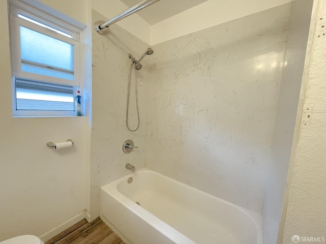 bathroom featuring tiled shower / bath and hardwood / wood-style floors