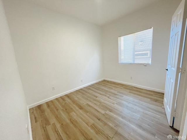 spare room with light hardwood / wood-style floors