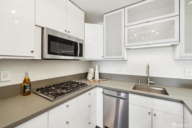 kitchen with sink, white cabinetry, and appliances with stainless steel finishes