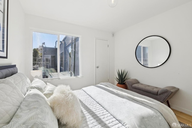 bedroom with hardwood / wood-style flooring