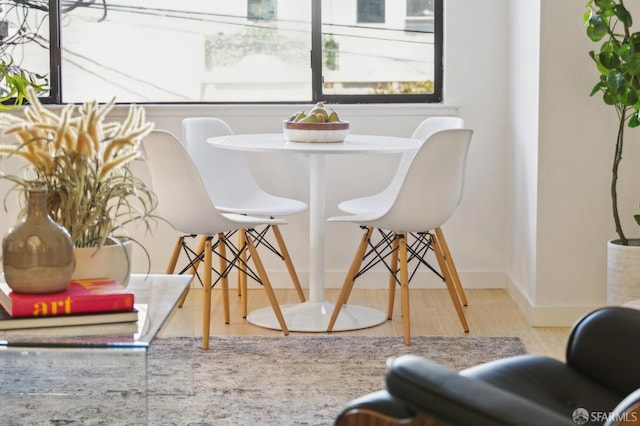 dining space with light hardwood / wood-style floors