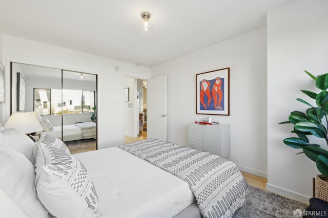 bedroom featuring light wood-type flooring and a closet