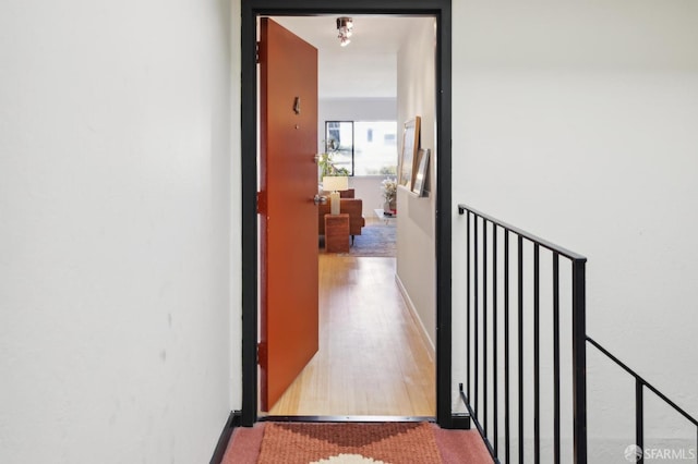 corridor with wood-type flooring