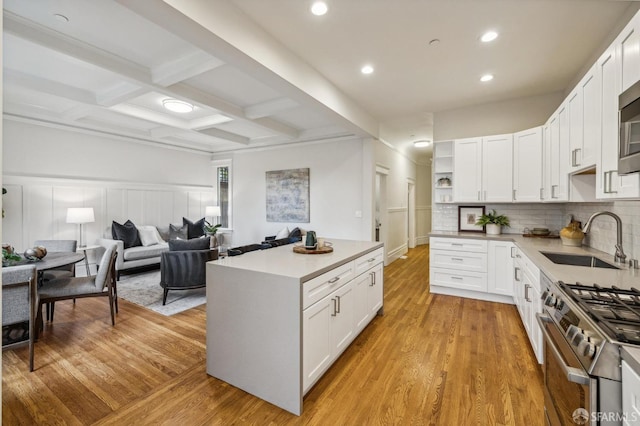 kitchen featuring sink, white cabinets, and light hardwood / wood-style flooring