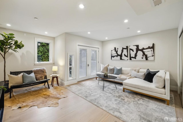 living room featuring french doors and light wood-type flooring