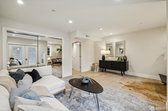 living room with light hardwood / wood-style floors and french doors