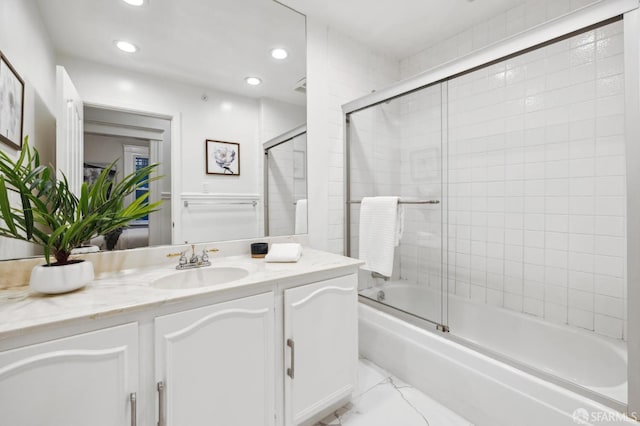 bathroom with vanity and enclosed tub / shower combo