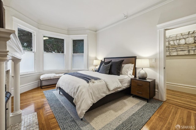 bedroom with hardwood / wood-style flooring and ornamental molding