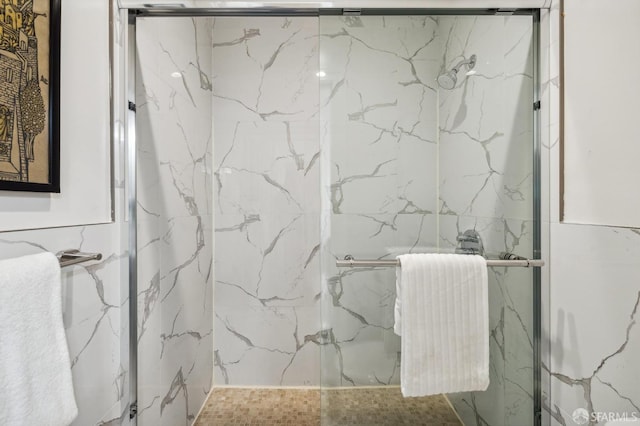 bathroom with radiator heating unit, an enclosed shower, and tile walls