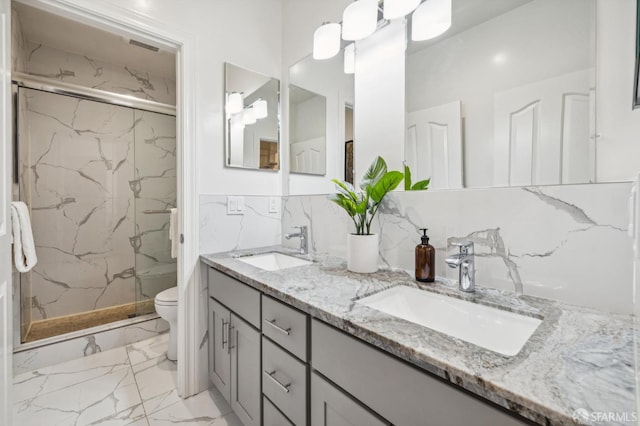 bathroom featuring toilet, an enclosed shower, and vanity