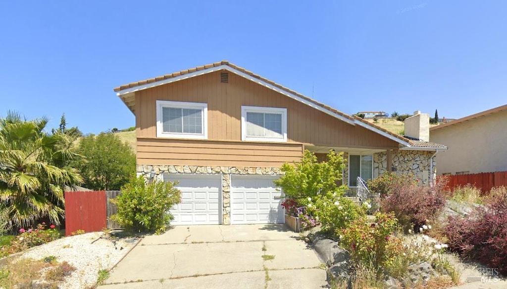 602 Fleming Ave E, Vallejo, CA 94591 - view of front of home with stone siding, driveway, and an attached garage