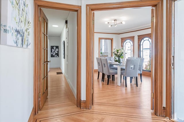 dining area featuring parquet floors, baseboards, and ornamental molding