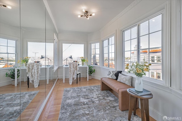 sunroom / solarium with a chandelier