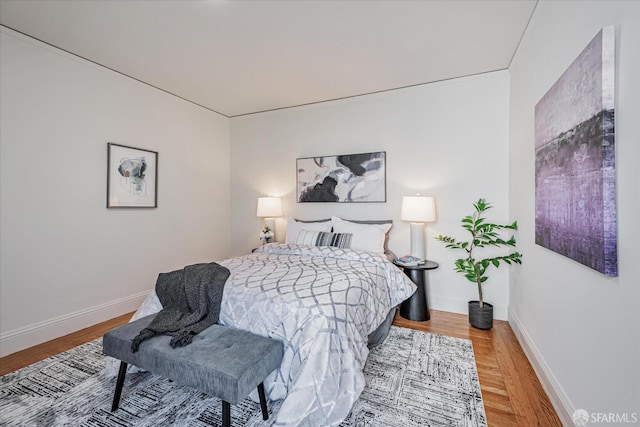 bedroom featuring baseboards and wood finished floors