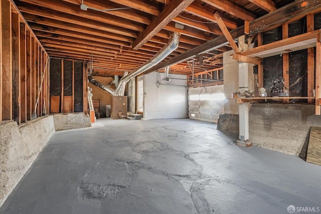 misc room featuring heating unit and unfinished concrete flooring