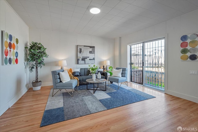 living room featuring a decorative wall and wood finished floors