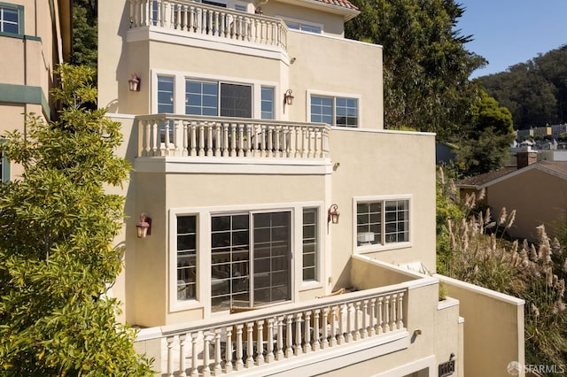 rear view of house featuring a balcony