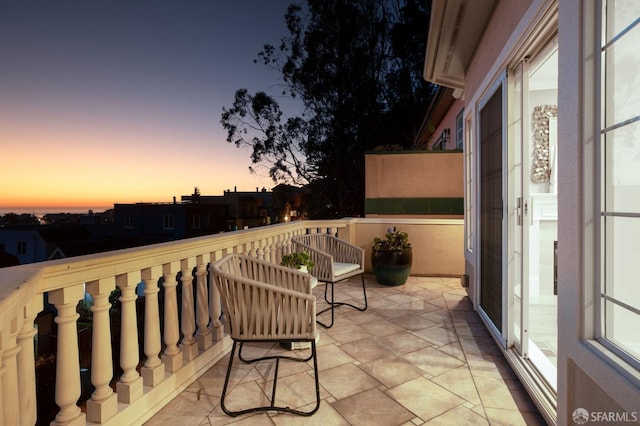 view of balcony at dusk