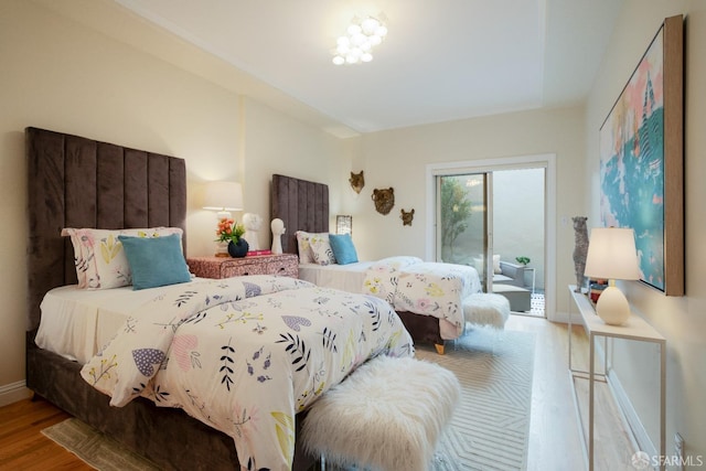 bedroom featuring access to outside and light wood-type flooring