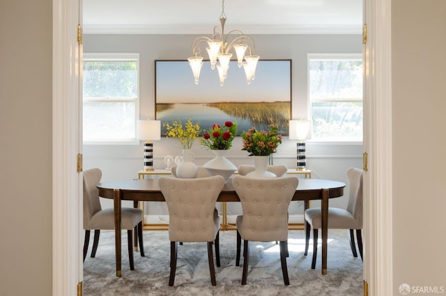 dining space featuring ornamental molding and a chandelier