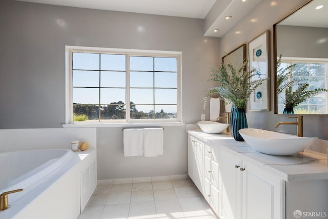 bathroom with a bathtub, tile patterned flooring, and vanity