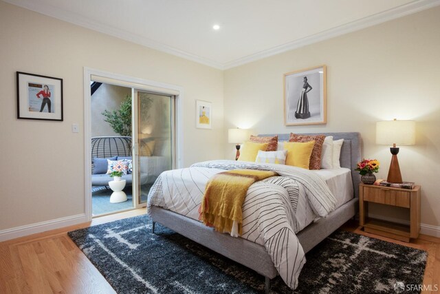 bedroom featuring ornamental molding, hardwood / wood-style floors, and access to outside