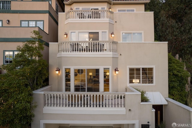 back of house with a balcony