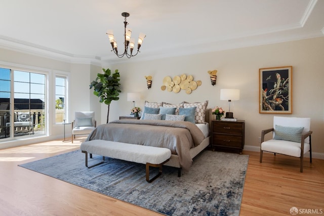 bedroom featuring ornamental molding, a chandelier, and light hardwood / wood-style flooring