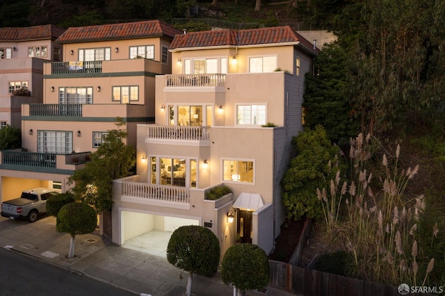 view of front of property with a garage and a balcony