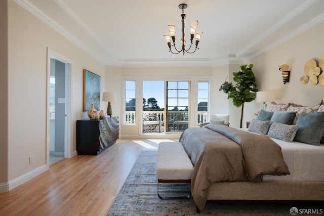 bedroom with ornamental molding, light wood-type flooring, ensuite bath, and a chandelier