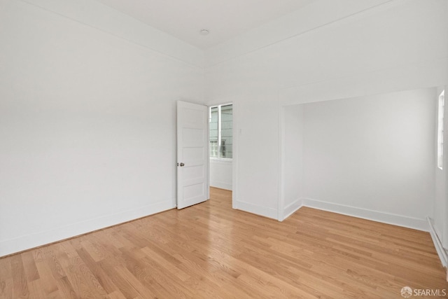 empty room with light hardwood / wood-style flooring