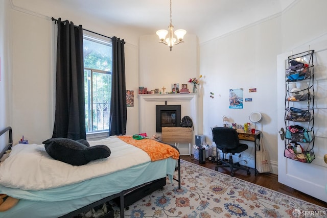 bedroom with a chandelier and dark hardwood / wood-style flooring