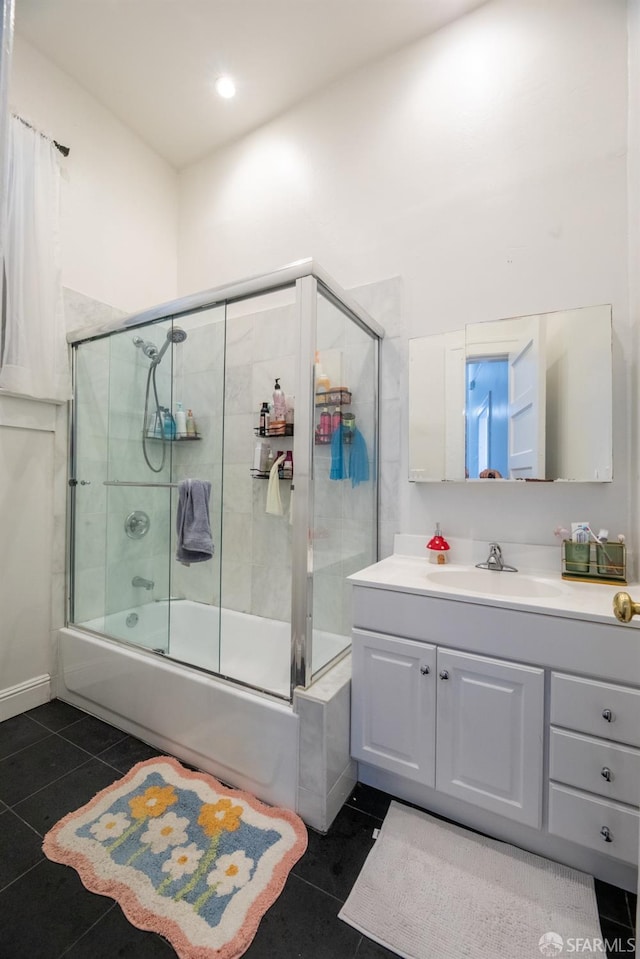 bathroom featuring combined bath / shower with glass door, vanity, and tile patterned floors