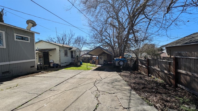 exterior space with concrete driveway and fence