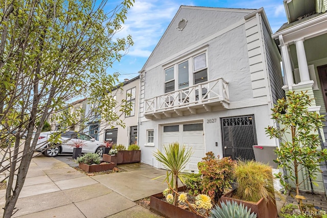 view of front facade with a garage and a balcony