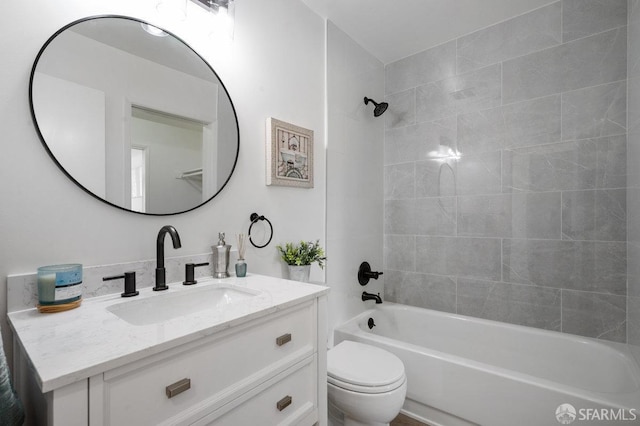 full bathroom with toilet, vanity, and tiled shower / bath