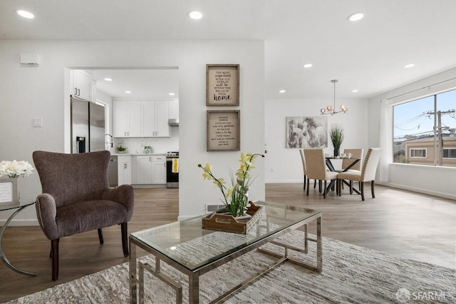 living room featuring hardwood / wood-style floors and a notable chandelier