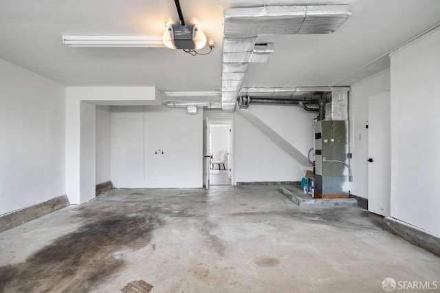 garage featuring a garage door opener and heating unit